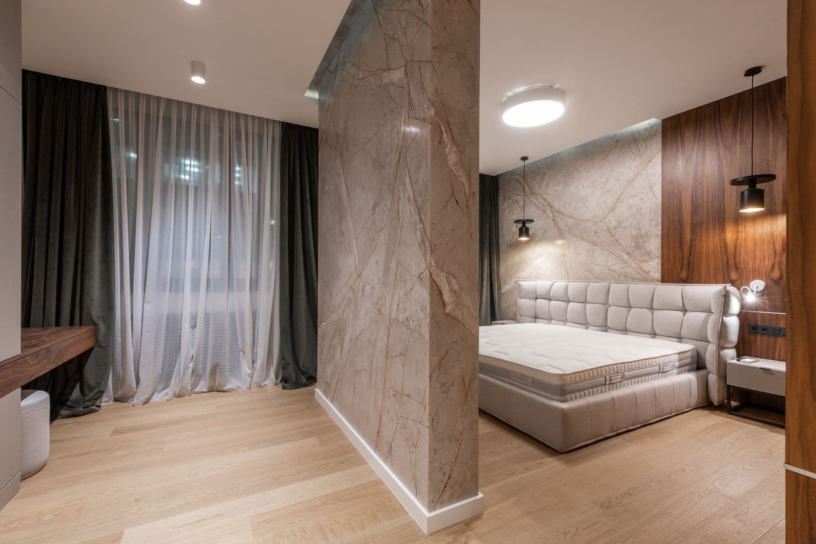 Quiet luxury bedroom with marble, walnut, and sage drapery